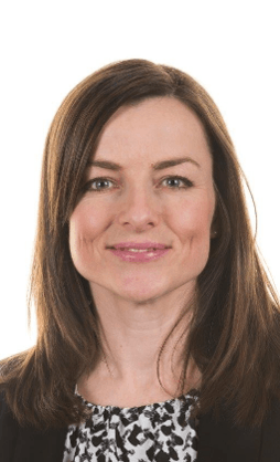 Headshot of a smiling woman with long brown hair.