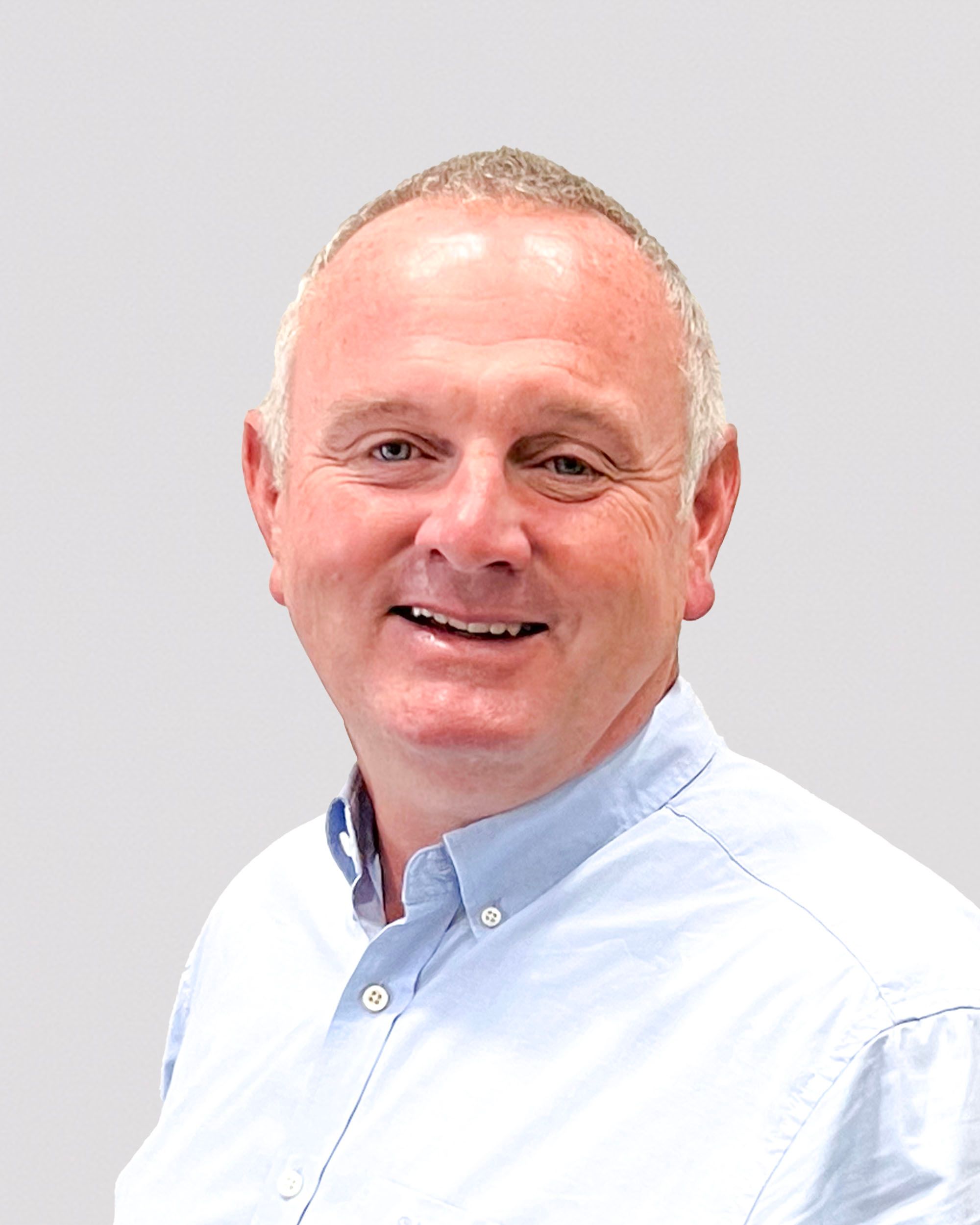 a man in a blue shirt is smiling for the camera