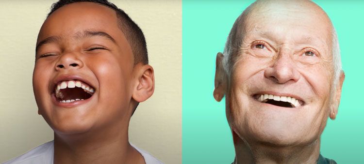 a young boy and an older man are laughing together .